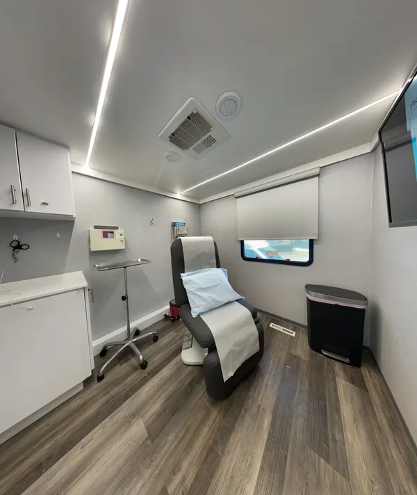 A fully equipped, private exam room inside an OnSpot Dermatology mobile clinic