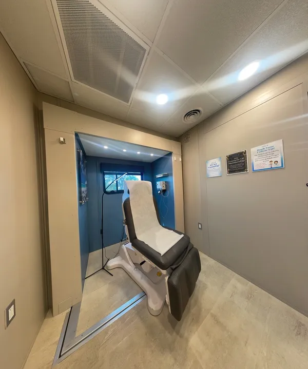 A private exam room with exam chair inside an OnSpot Dermatology mobile clinic