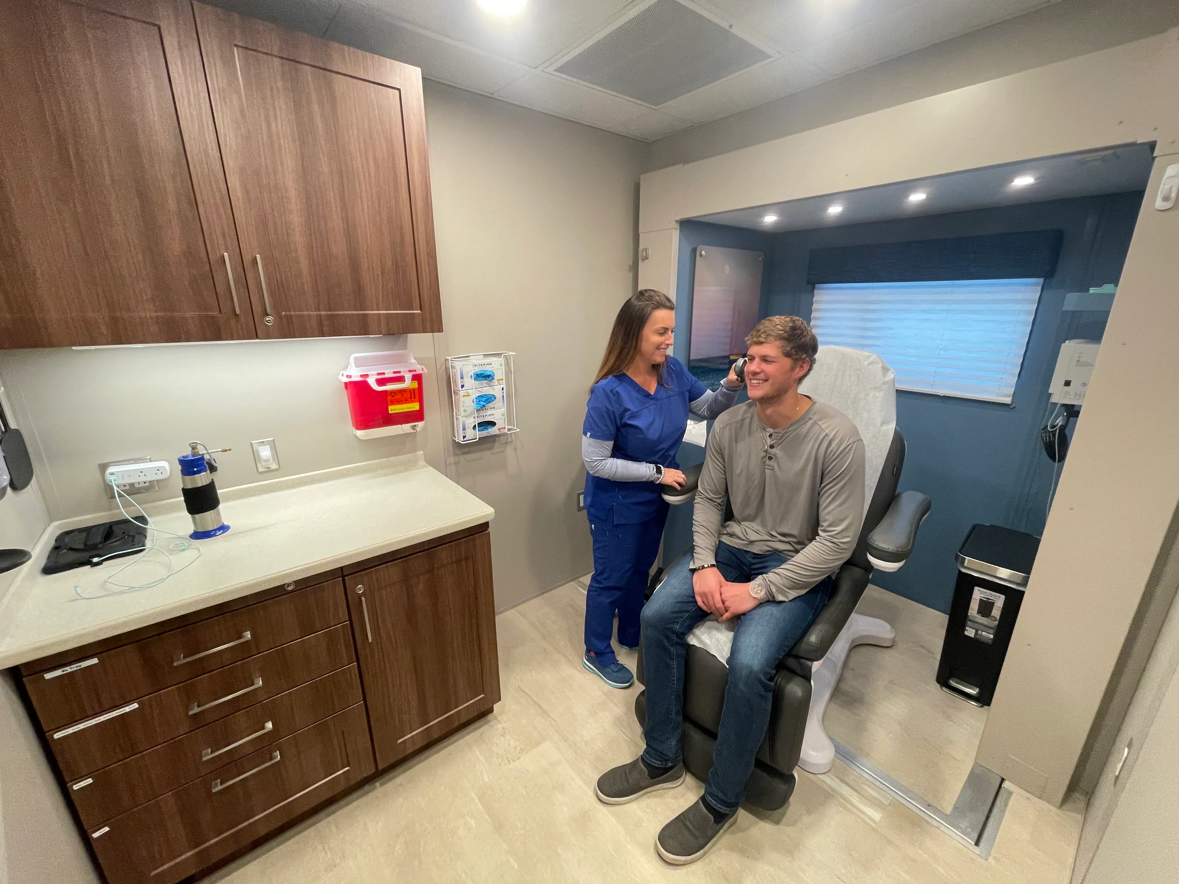 Patient receiving dermatology exam inside OnSpot mobile unit